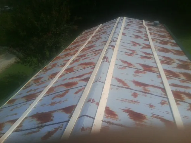 Rusted metal roof panels with new wood purlins before replacement — Storm Damage Roof Repair in Tower City by Roofing Brothers